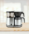 Bonavita 5-Cup One-Touch Thermal Carafe Coffee Brewer side profile on table.